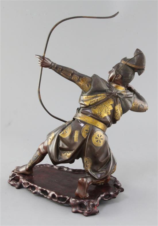 A Japanese bronze and parcel gilt figure of a kneeling archer, signed Yoshimitsu, Meiji period, height 37.5cm incl. carved wood stand
